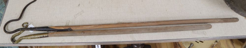 Two 19th century iron Shepherds crooks, one neck, one leg, the latter with a replacement handle, largest 140cm